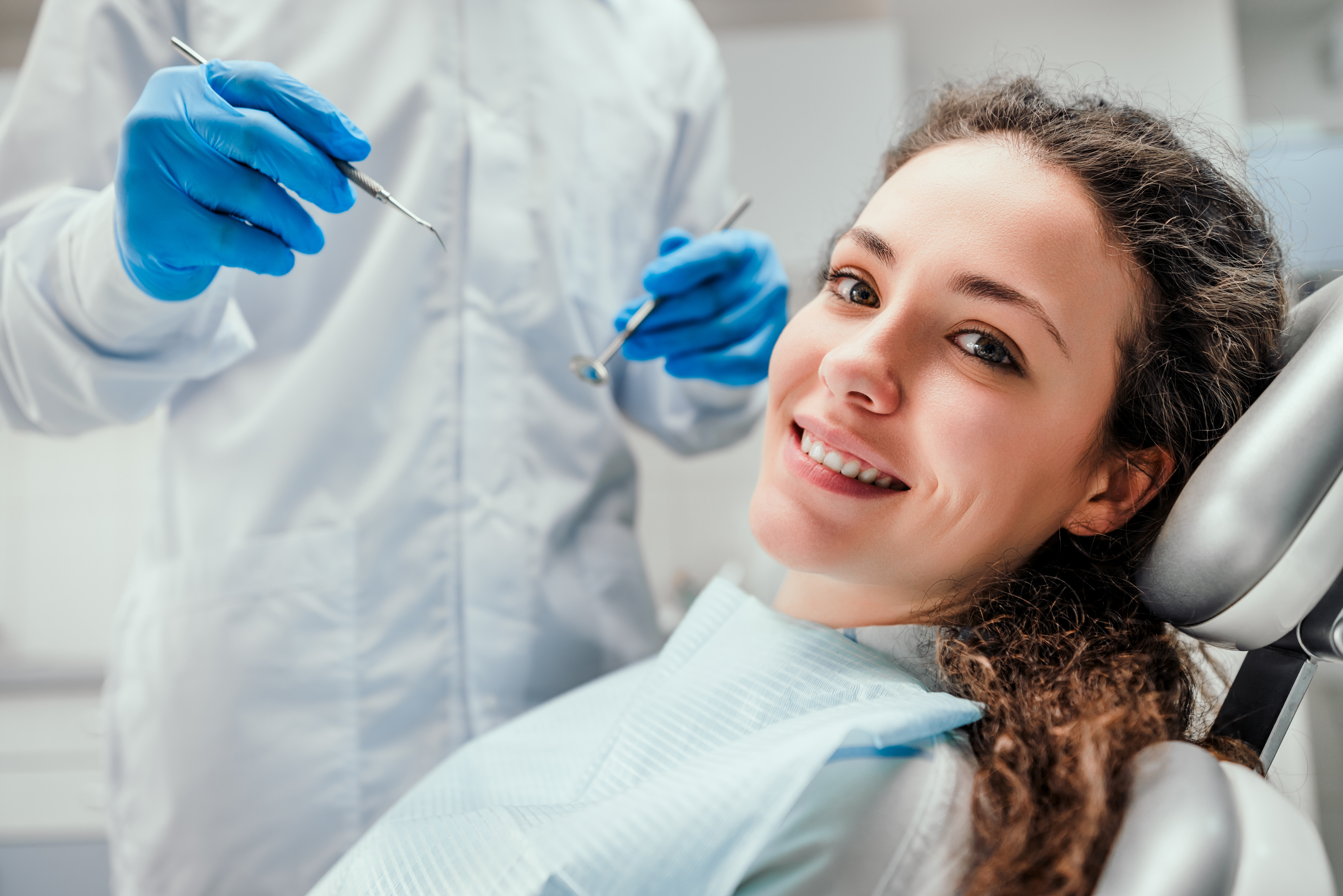 young woman in dentist chair, smiling