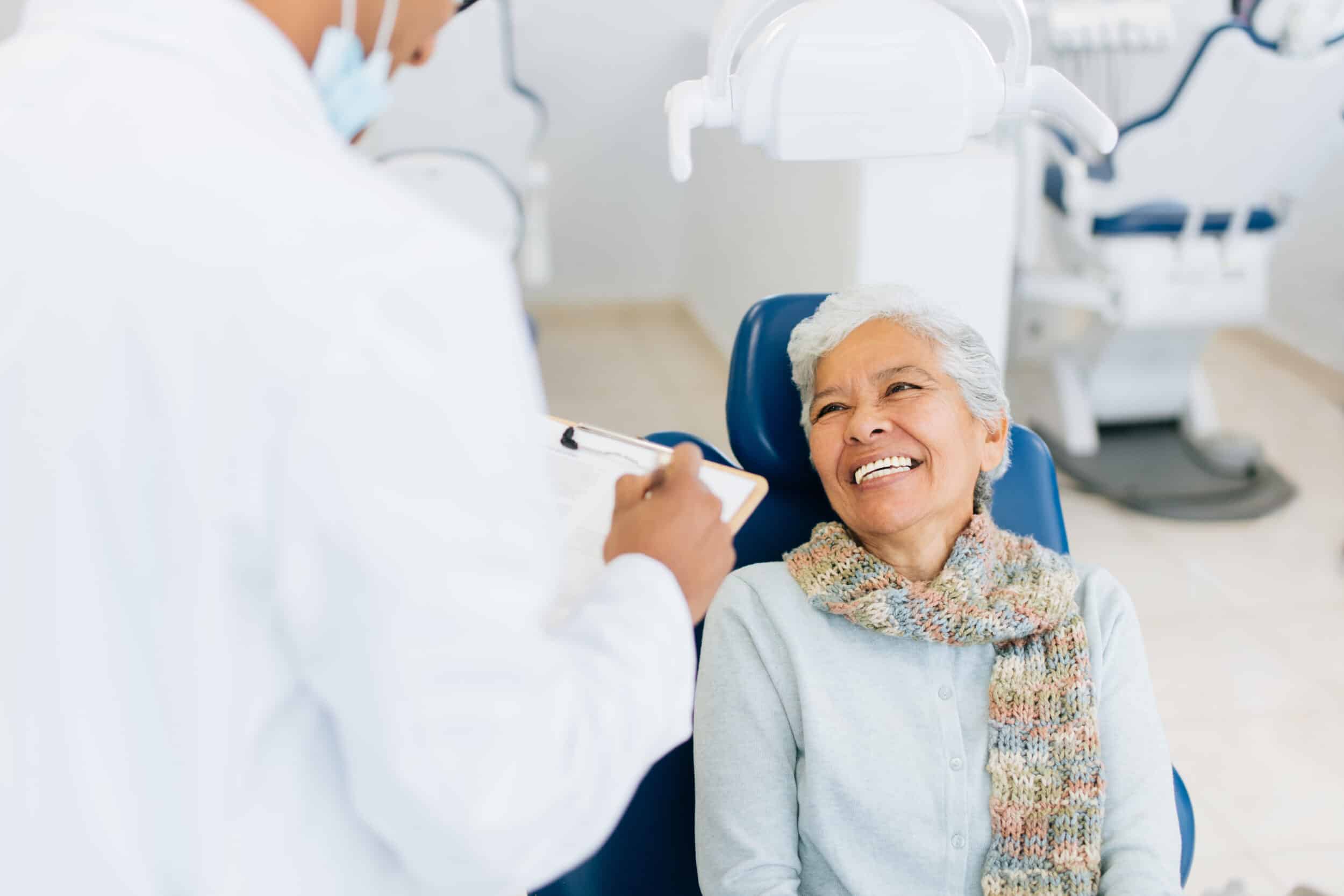 Happy smiling senior woman with male dentist