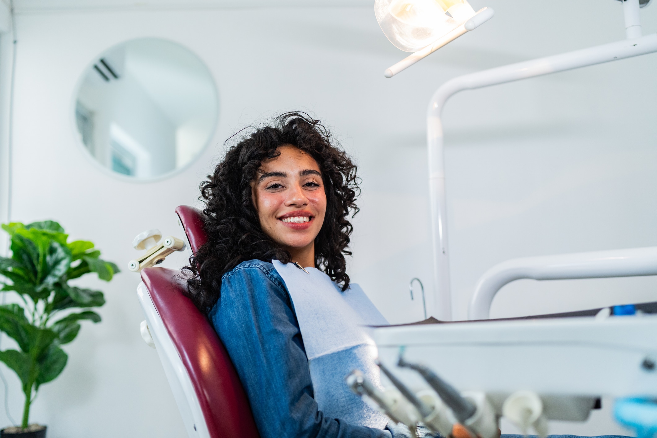 Smiling patient seated in a dental chair before an evaluation for early tooth decay and remineralization treatment.jpg